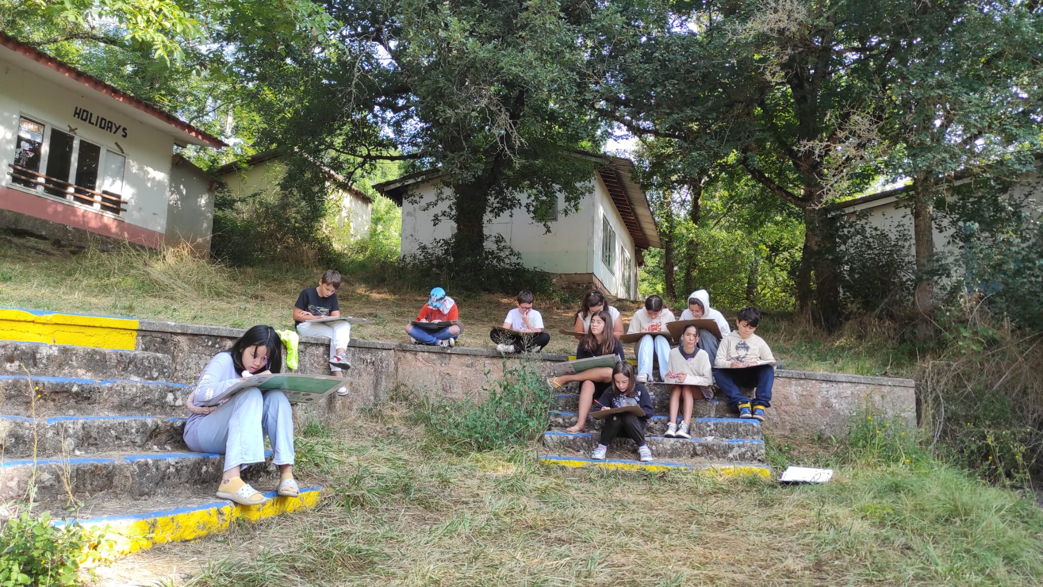 Enfants partageant leurs techniques de dessin manga lors d'une colonie de vacances